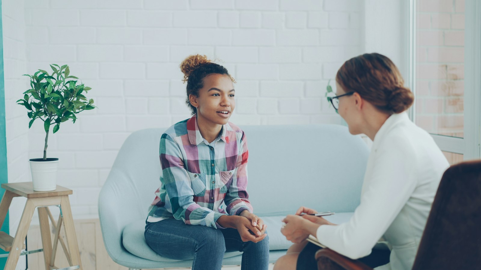 A clinician talking with a patient during a consultation